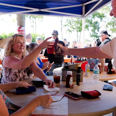 People sharing drinks at table.