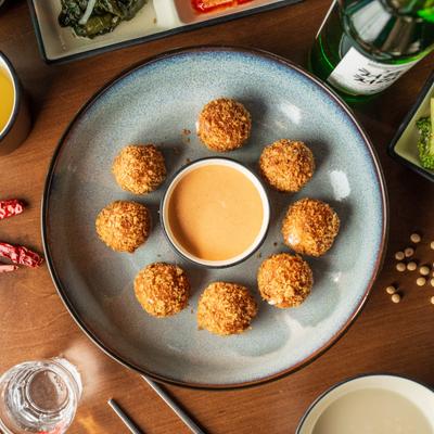 Fried Soy Balls with mozzarella cheese , served with a dipping sauce.