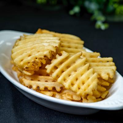 Portion of waffle fries served on the table.