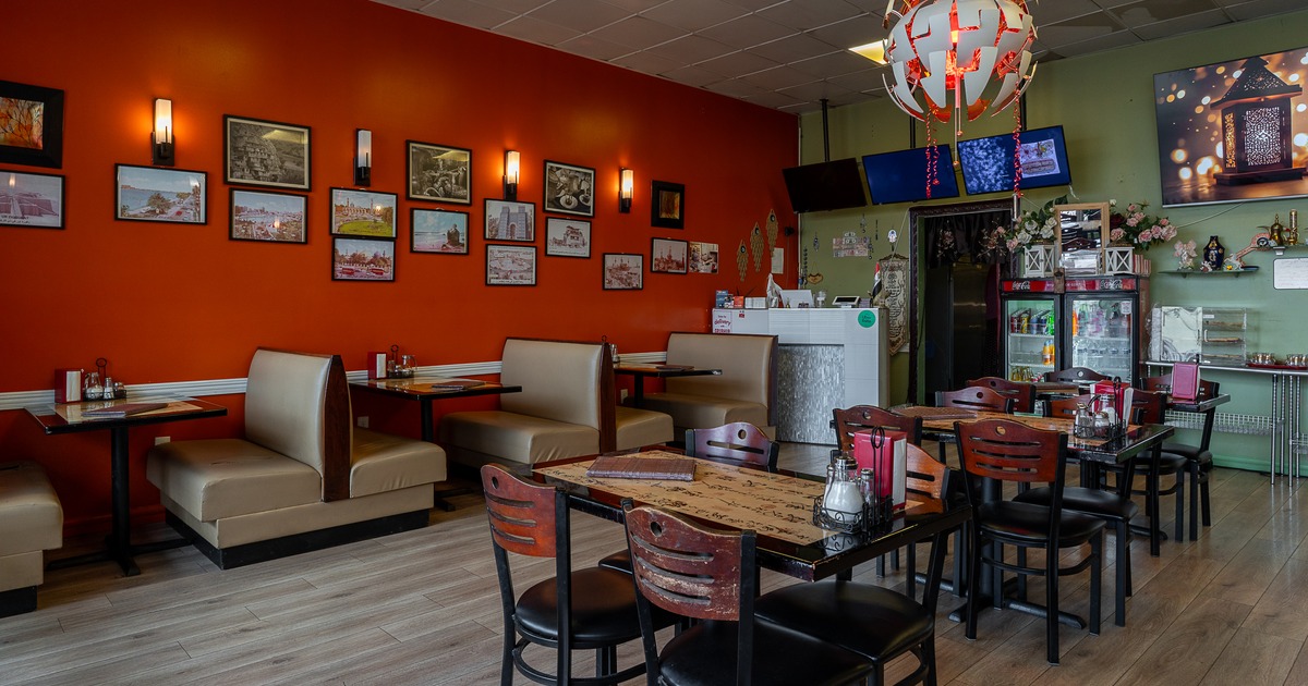 Cozy interior dining area with upholstered dining booths, tables and chairs