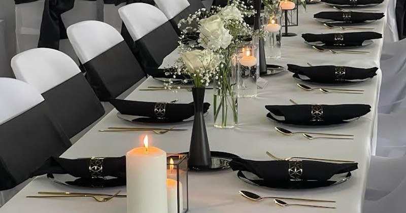 A long table elegantly set with place settings for a dining gathering