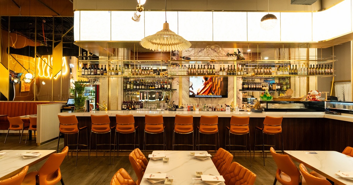 tylish restaurant interior featuring a modern bar, elegant lighting, and comfortable seating