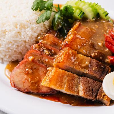 Thai roasted pork rice served with cucamber slices.