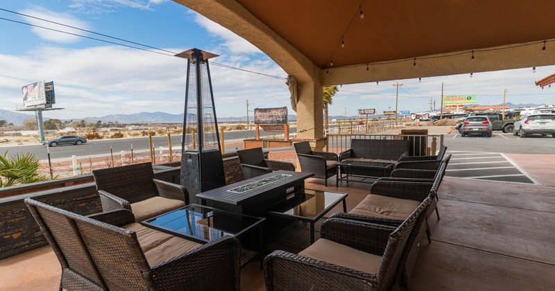 Covered patio with empty chairs and tables waiting for guests