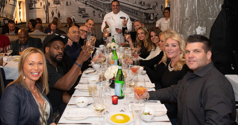 Customers posing for picture at table