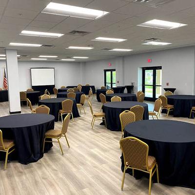 Skirted black tables with chairs.