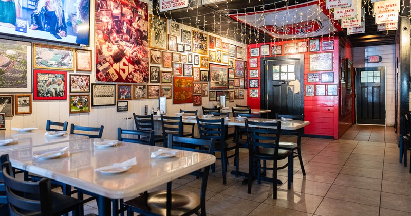 Interior of a sports-themed restaurant with sports memorabilia on the walls