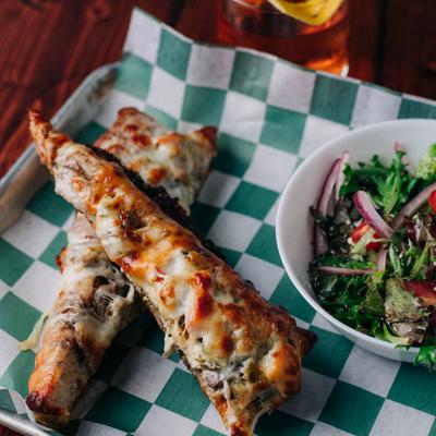 Tri tip steak covered in cheese.