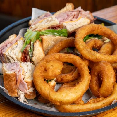Club sandwich with onion rings.