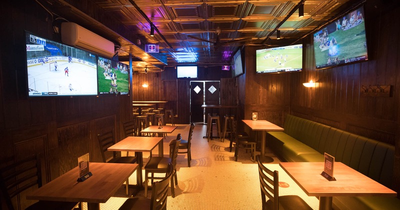 Interior, tables and seating, large TV screens on the walls