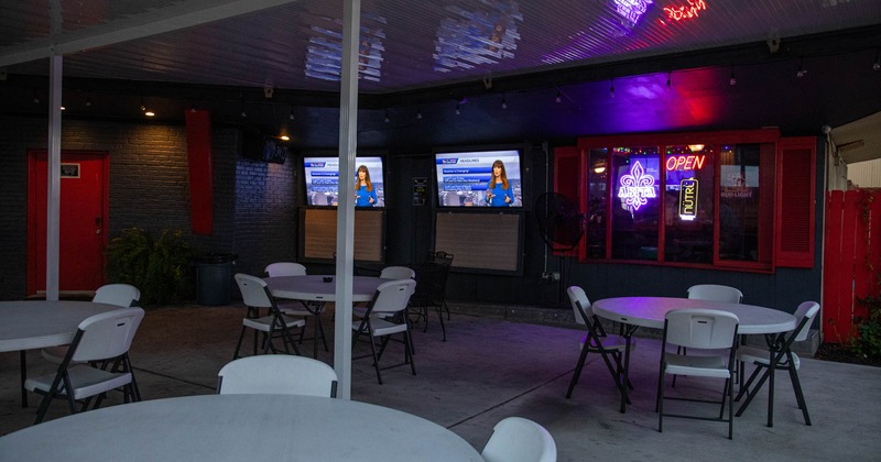 Exterior, tables and chairs, tv screens on the wall