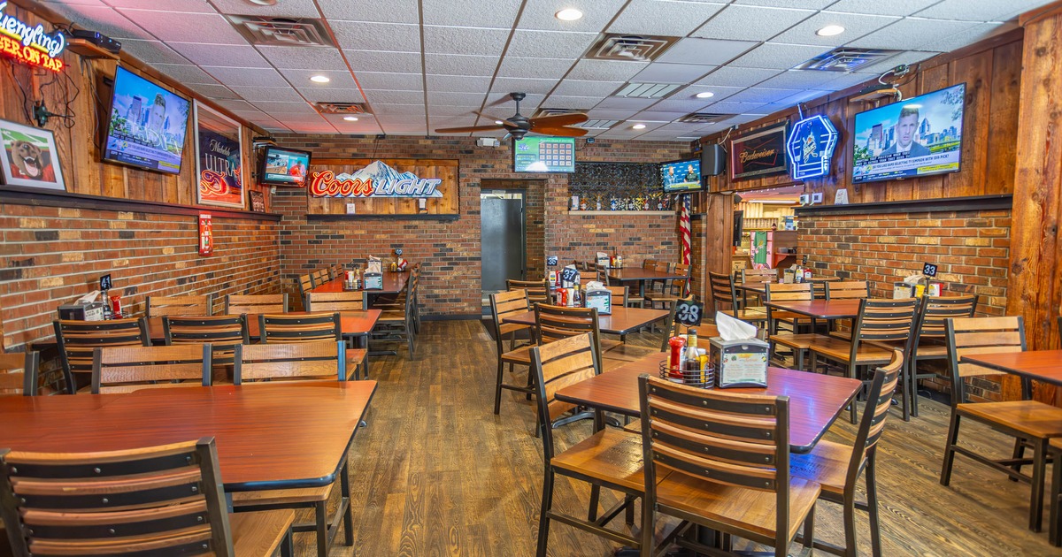 Interior, chairs and tables, TV's on the walls
