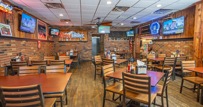 Interior, chairs and tables, TV's on the walls