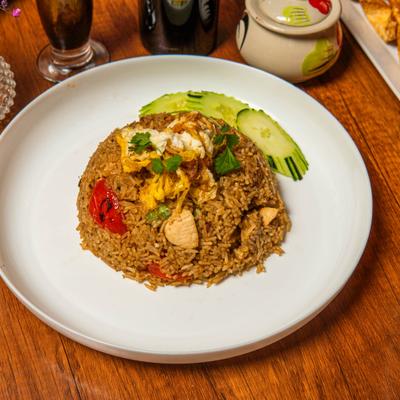 Basil Fried Rice with chicken, egg, onion, bell pepper and fresh cucumber garnish.