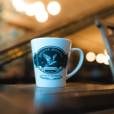 A coffee mug with the cafeteria's logo.