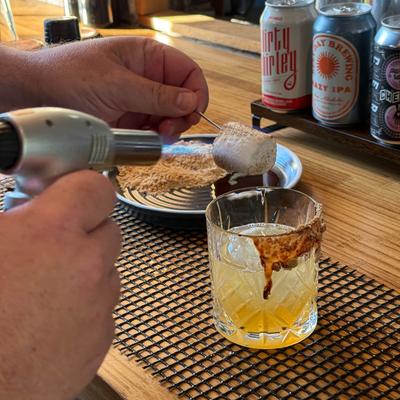 Bartender toasting a marshmallow.