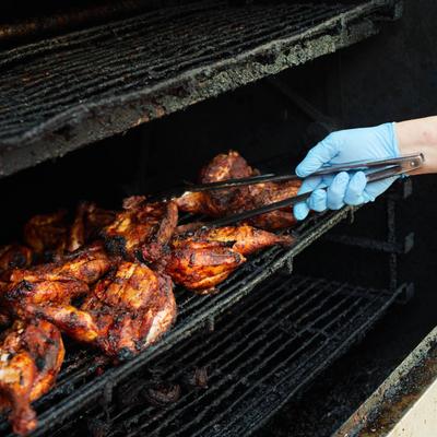 Employee smoking chicken.