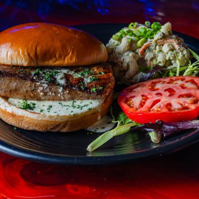 Fish sandwich served with mac and cheese.