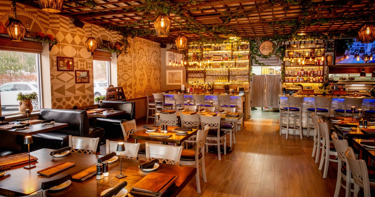 Interior, dining area, booths with tables on the left, regular tables for two, four and six