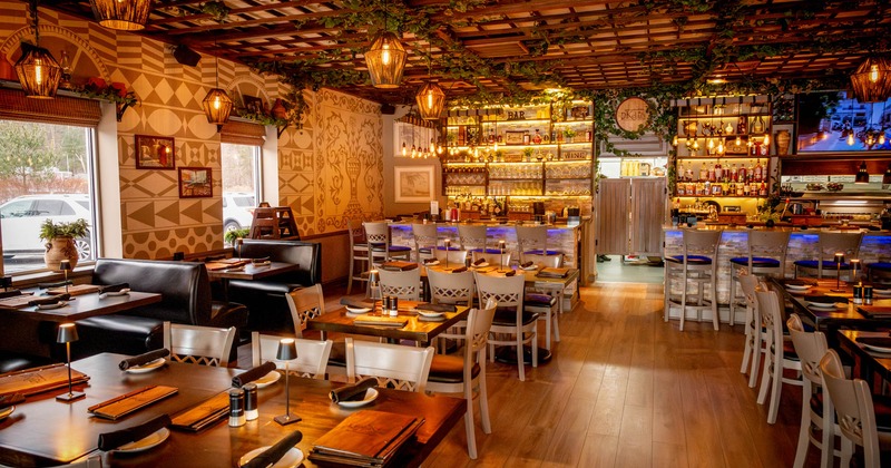 Interior, dining area, booths with tables on the left, regular tables for two, four and six