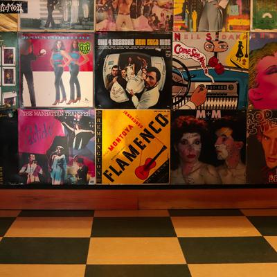 A wall of colorful vintage vinyl record covers.