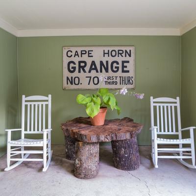 Table and two chairs with Cape Horn sign in the back