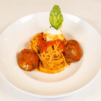 Spaghetti and meatballs featuring a tomato sauce, ricotta and fresh basil.