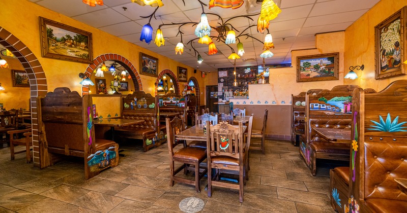 Interior, tables, chairs, booths, lights, paintings on walls