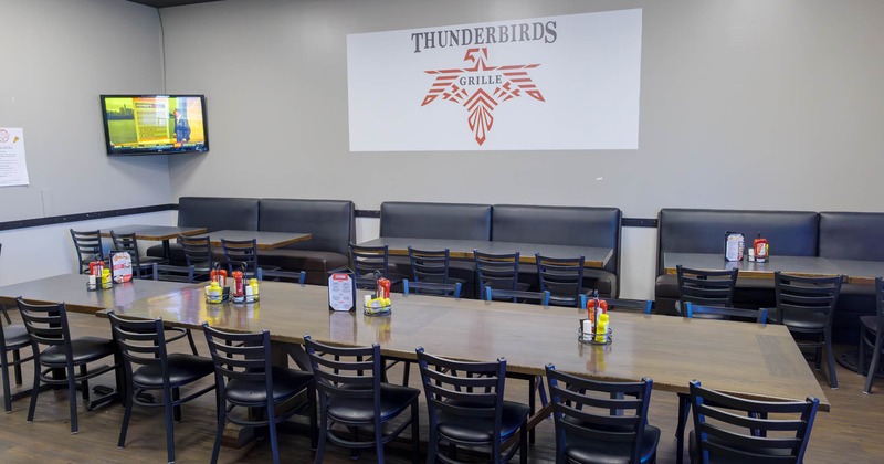 Interior, tables with chairs and booths in the back