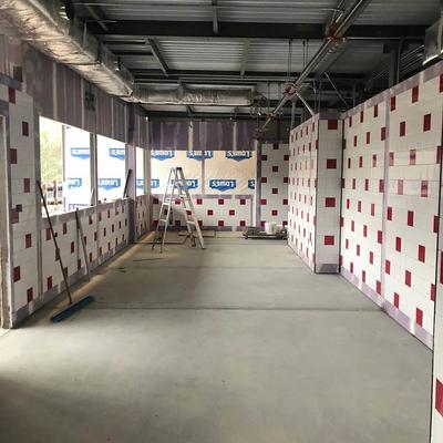 An empty room with red and white tiled walls