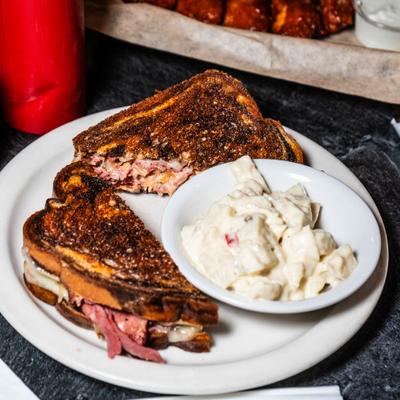 Reuben sandwich with potato salad.