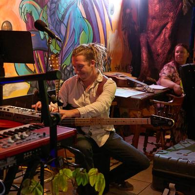 Musicians performing live at the bar stage.