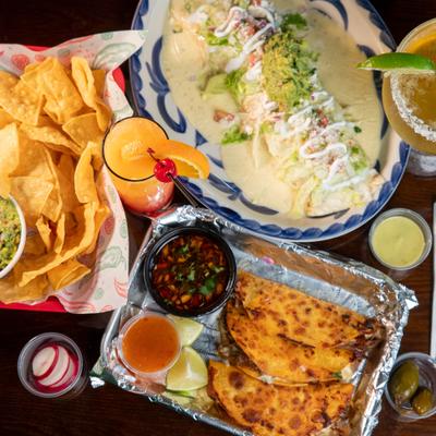 Various dishes served on the table alongside drinks and condiments.