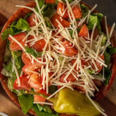 Mixed vegetables salad, toped with cheese, top view.