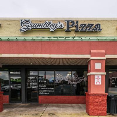 The storefront of Grumbley's Pizza.