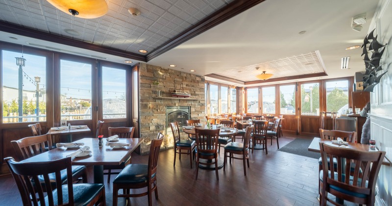 Interior, dining area, wooden top tables for two, four and five people, ready for guests