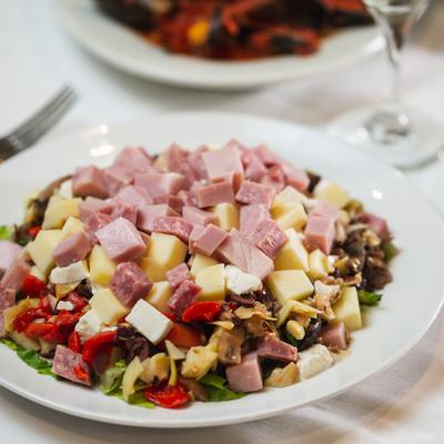 Chopped Antipasto, served on a plate with cutlery