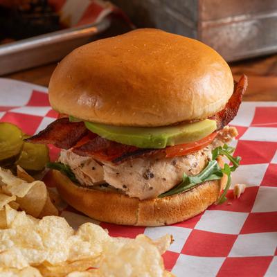 Grilled chicken sandwich, with BBQ sauce, bacon, avocado, lettuce, and tomato.