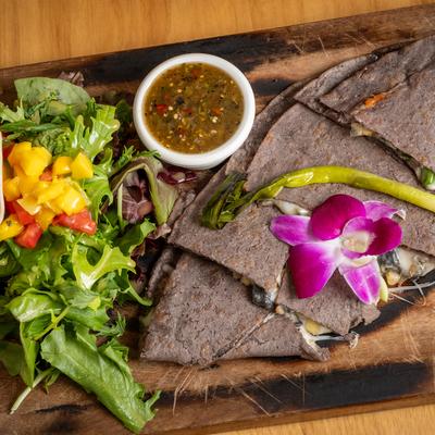 Fresh blue corn tortillas with vegetables.