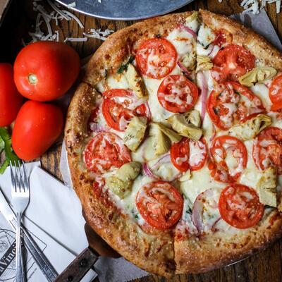 Pizza with extra cheese and tomato