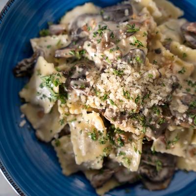 Ravioli di Carne House made small ravioli filled with mortadella, Beef and pork in a Prosciutto, mushroom cream sauce.