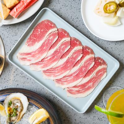 American Wagyu chuck eye roll, sliced and served on a tray.