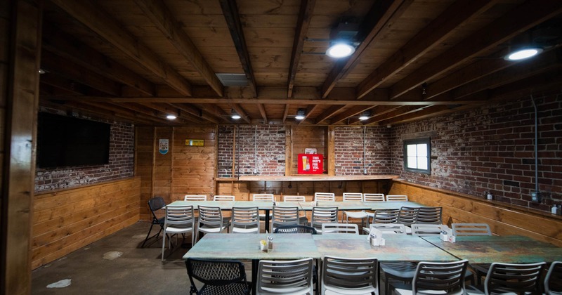 Interior, tables and chairs, TV screen on the wall