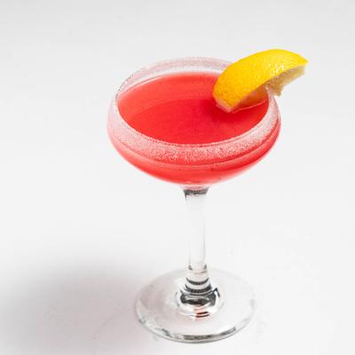 Raspberry Martini, garnished with lemon wedge.
