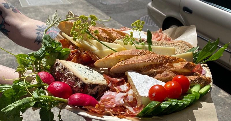 A vibrant charcuterie board held outdoors