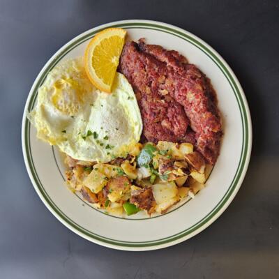 Corned Beef Hash and eggs, and home fried potatoes, orange slice..