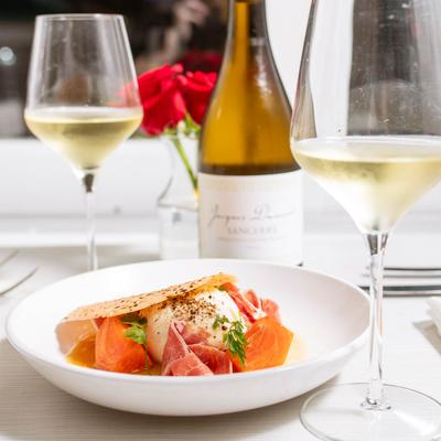 Burrata, served with persimmon, ham, ponzu sauce, and spices