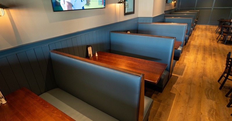 Booth tables with leather upholstered seats