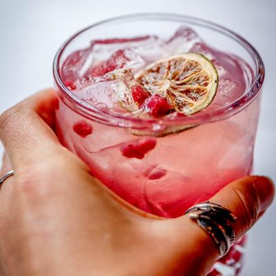 A hand holding a sangria drink.