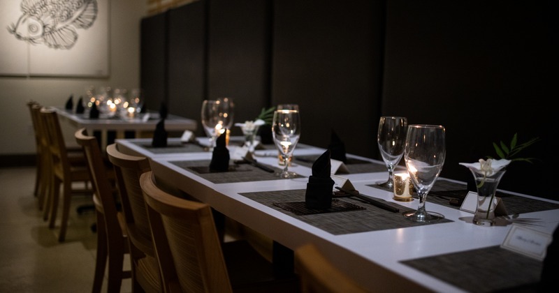 Raw of tables set with napkins, cutlery and glasses